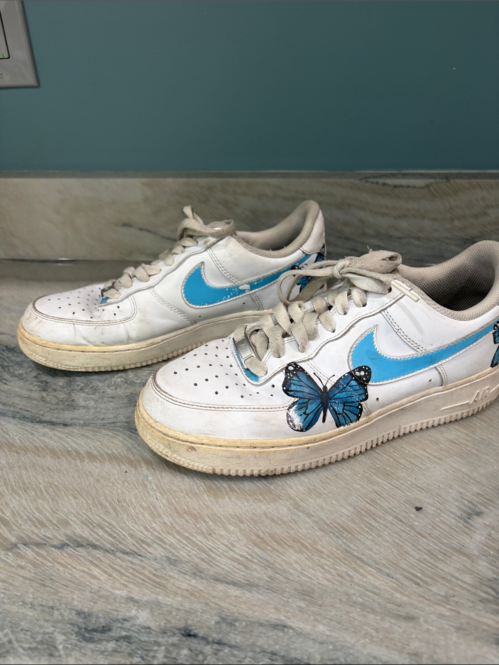 Nike White Sneakers with Blue Swoosh and Butterfly Accent